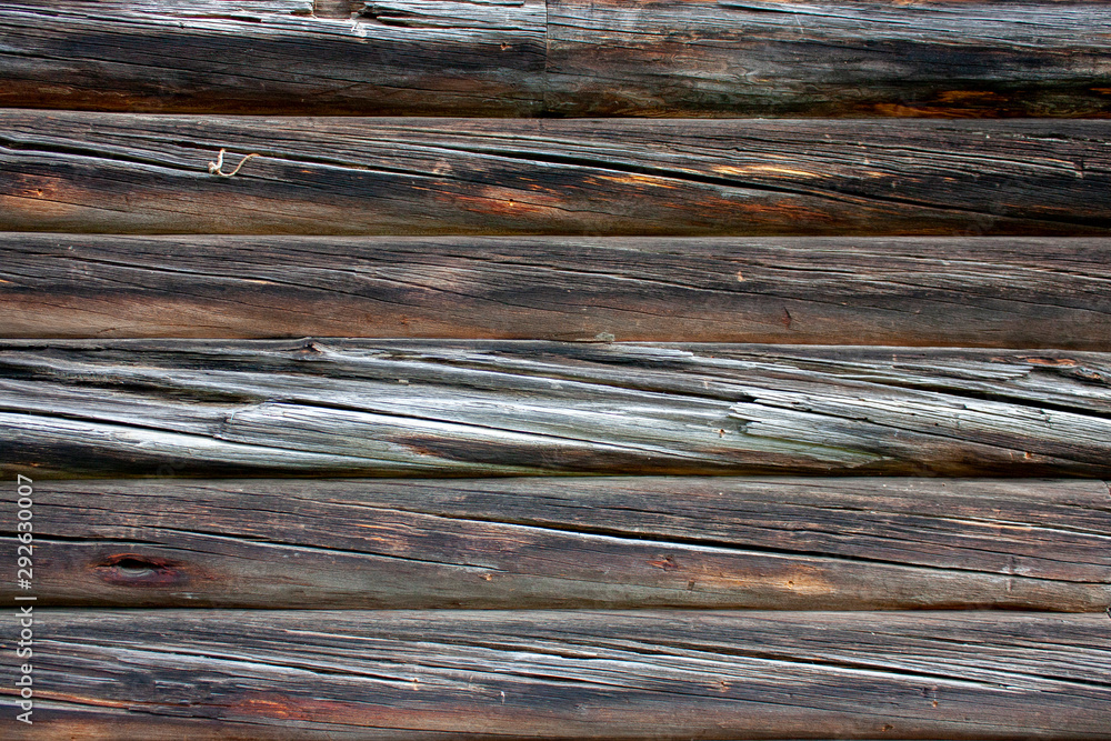 Wall made of old logs natural wood. Natural wood texture pattern. Natural wood cladding Wall made of old logs natural wood. Natural wood texture pattern. Natural wood cladding