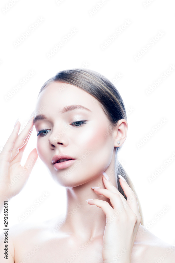 Beauty portrait of young model woman touching perfect skin, apply cosmetics cream makeup. Isolated. White background. Copy space
