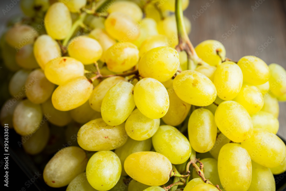 Ripe green grape on the rustic background. Selective focus. Shallow depth of field. Ripe green grape on the rustic background. Selective focus. Shallow depth of field.