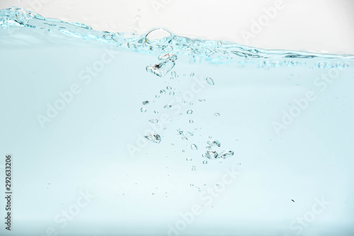 Blue water splash and air bubbles isolate on white background