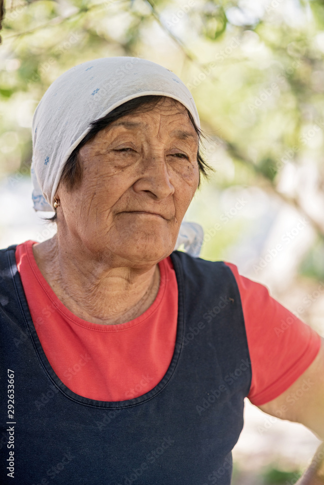 Portrait of an elderly woman in the garden. Photographed close-up. Portrait of an elderly woman in the garden. Photographed close-up.