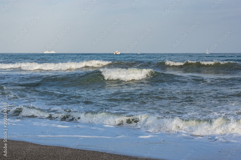 The sea is worry, waves with foam. The white ships on the horizon. The sea is worry, waves with foam. The white ships on the horizon.