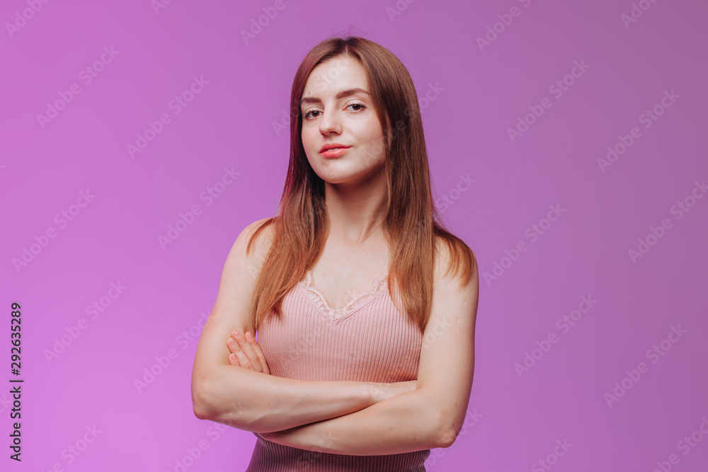girl crossed her arms against the pink background girl crossed her arms against the pink background