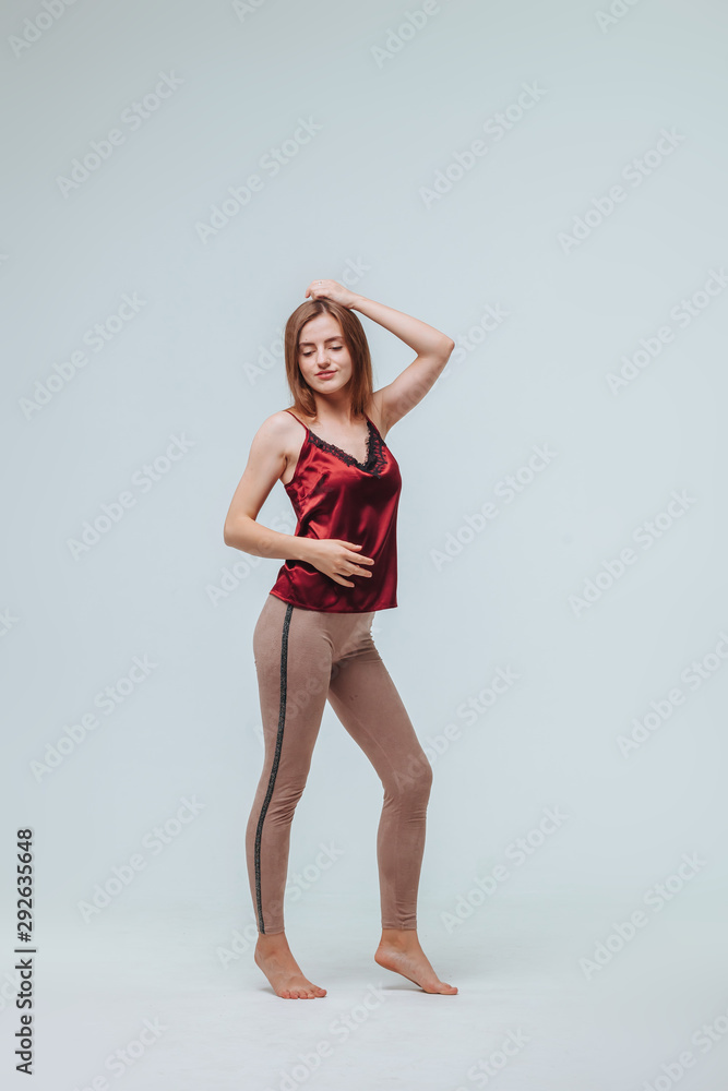 Girl in leggings and blouse on grey background Girl in leggings and blouse on grey background