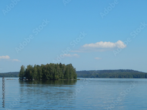 Scenic view of a lake with a small island on a sunny summer day