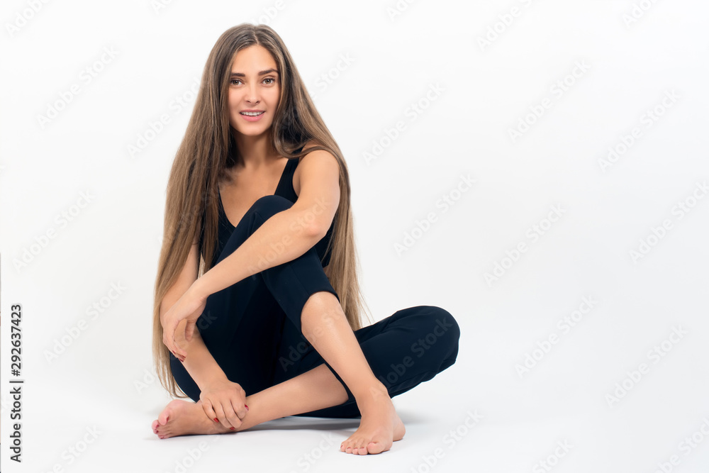 Portrait of a young modern smiling girl in the Studio on a light background, the concept of beauty and fashion Portrait of a young modern smiling girl in the Studio on a light background, the concept of beauty and fashion