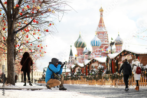 Canvas Print Journey. Tourist with a camera takes photos of beautiful places.