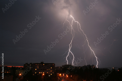Thunderstorm and lightning in the night sky over the city