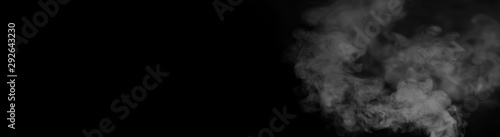 White smoke on a black background. Texture of smoke. Clubs of white smoke on a dark background for an overlay