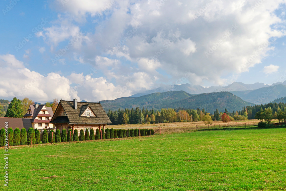 ZAKOPANE, POLAND - JULY 27, 2018: Highlanders houses and panorama of the Tarta mountains ZAKOPANE, POLAND - JULY 27, 2018: Highlanders houses and panorama of the Tarta mountains