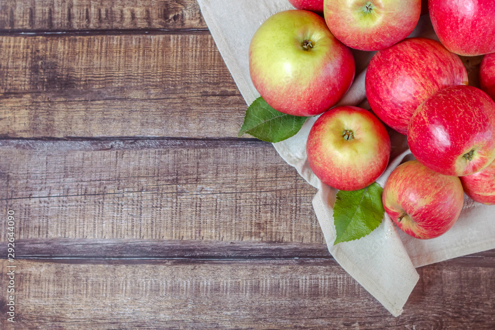 Red apples on dark wooden background. Autumn harvest. Flat lay. Selective focus. Red apples on dark wooden background. Autumn harvest. Flat lay. Selective focus.