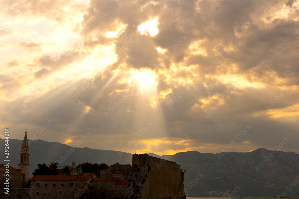 Rays sun falling through clouds on the old city. Selective focus.