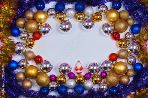 Glitter Christmas balls pattern. Flat lay, top view, copy space. Christmas golden,red,violet, blue and silver balls decorations on white background. New year creative arrangement frame.