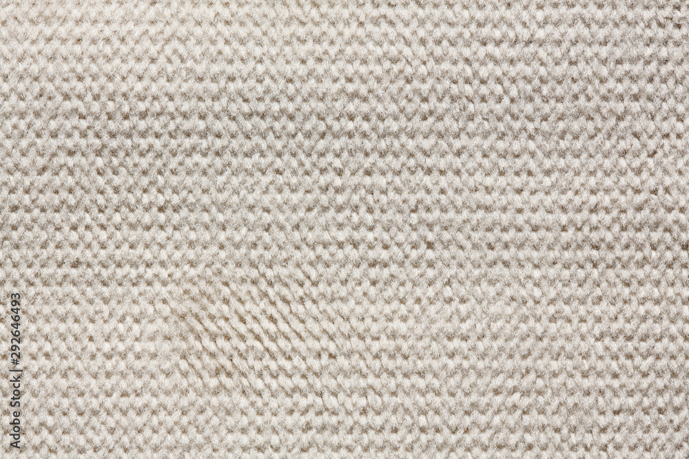 Knitted material background in light tone. Knitted material background in light tone.