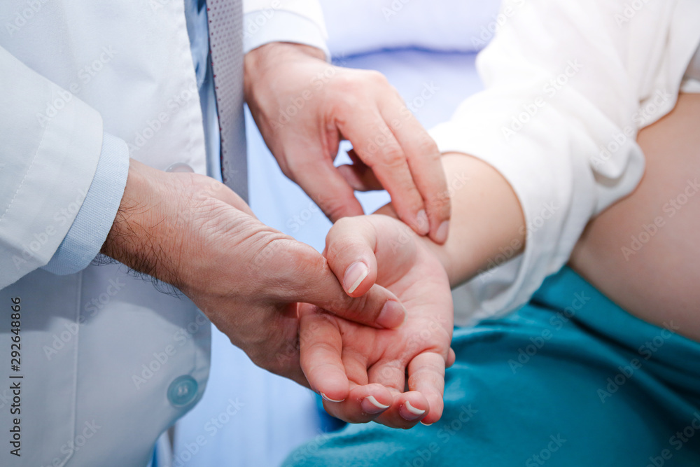 Asian doctors use the pulse hand grip on the right wrist of a Chinese pregnant woman. Patient treatment concept Asian doctors use the pulse hand grip on the right wrist of a Chinese pregnant woman. Patient treatment concept