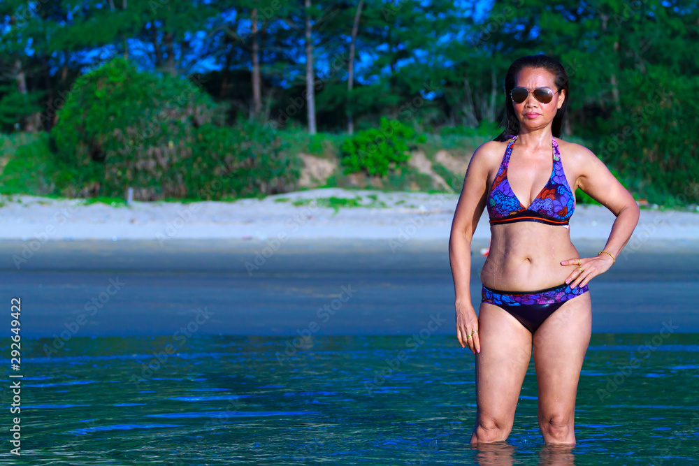 Woman shape pretty show bikini on beach Woman shape pretty show bikini on beach