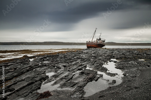 Abandoned ship on the coast of the Arctic Ocean. photo