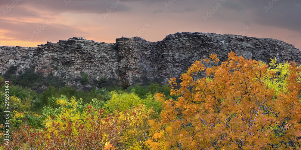 Royal rocks in the Proval Steppe nature reserve in Ukraine in autumn, surrounded by yellowed trees