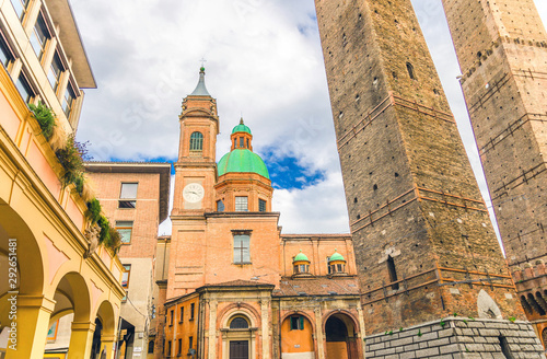 Two medieval towers of Bologna Le Due Torri: Asinelli and Garisenda and Chiesa di San Bartolomeo Gaetano church on Piazza di Porta Ravegnana square in old historical city centre, Emilia-Romagna, Italy photo