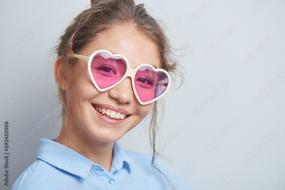 Portrait of a cheerful asian kazakh young woman in stylish glasses dressed casual smiling joyfully isolated on a white background Portrait of a cheerful asian kazakh young woman in stylish glasses dressed casual smiling joyfully isolated on a white background