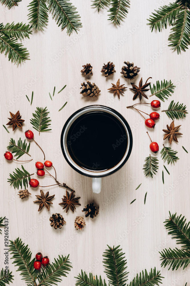 Christmas composition. A cup of coffee, tree branches, pine cone and berries on wooden background. Christmas, winter, new year concept. Flat lay, top view, copy space Christmas composition. A cup of coffee, tree branches, pine cone and berries on wooden background. Christmas, winter, new year concept. Flat lay, top view, copy space
