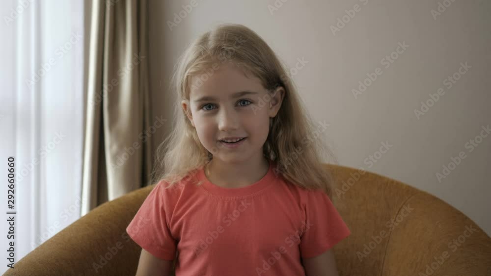 Kid Child Girl Making Online Video Call Recording Vlog Sitting On Sofa , Portrait. Funny Girl Smiling Looking At Camera. Happy Cute Little Vlogger Saying Hello Hi Looking At Camera Talking To Webcam. Stock ビデオ | Adobe Stock