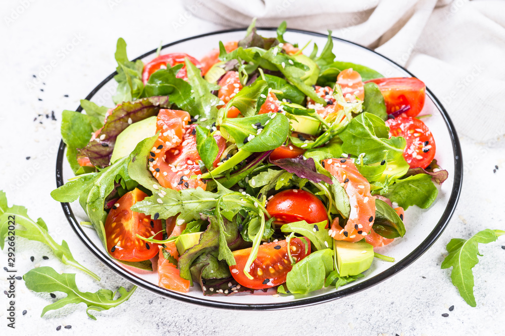 Salmon salad with green leaves on white. Salmon salad with green leaves on white.