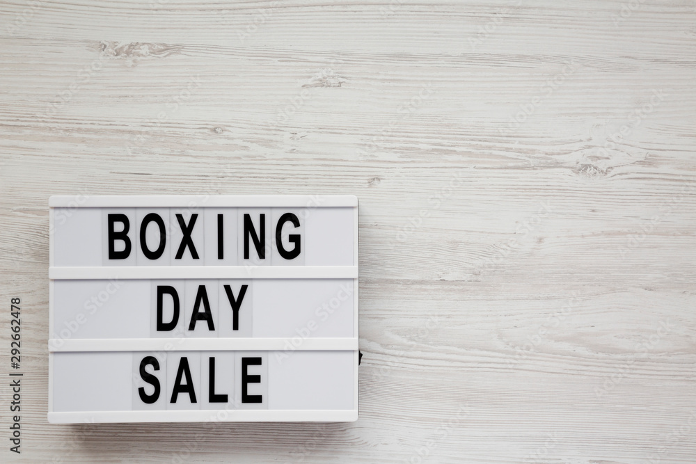 'Boxing day sale' words on a modern board on a white wooden surface, top view. Overhead, from above, flat lay. Space for text. 'Boxing day sale' words on a modern board on a white wooden surface, top view. Overhead, from above, flat lay. Space for text.