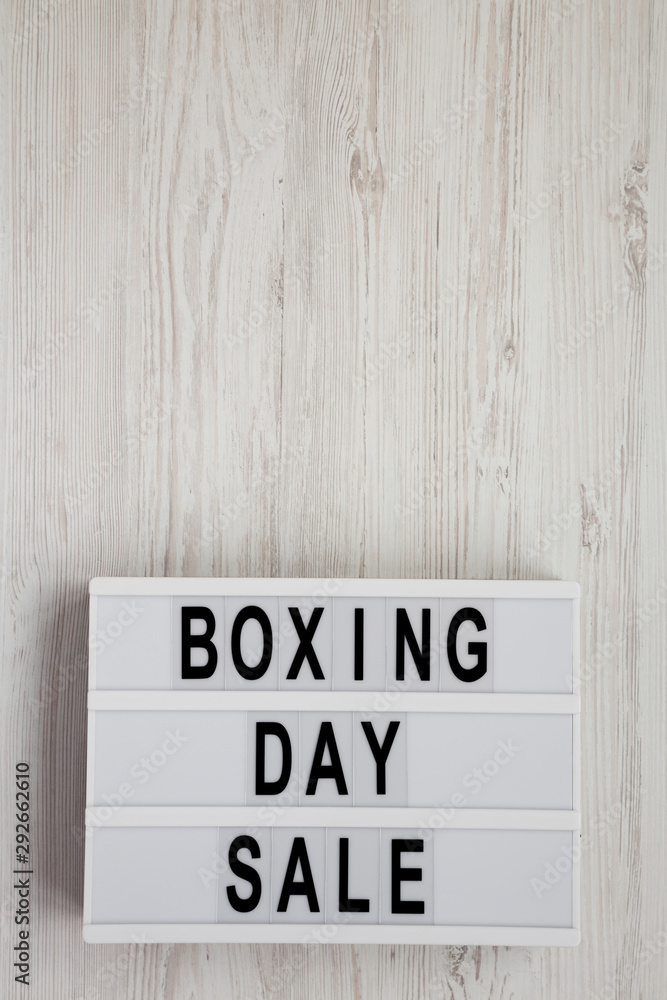 'Boxing day sale' words on a lightbox on a white wooden surface, top view. Overhead, from above, flat lay. Copy space. 'Boxing day sale' words on a lightbox on a white wooden surface, top view. Overhead, from above, flat lay. Copy space.