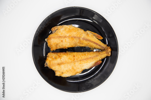 Fried river perch on a black plate. Natural eco fresh water - river fish  on a white background.