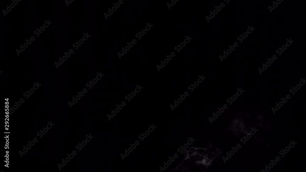 White filament smoke from incense sticks swirls in the dark. Small cloud flows on a black background, place for text. White filament smoke from incense sticks swirls in the dark. Small cloud flows on a black background, place for text.
