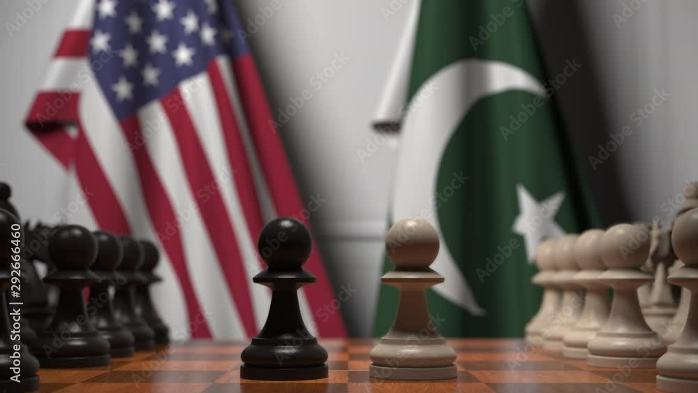 Flags of USA and Pakistan behind pawns on the chessboard. Chess game or ...