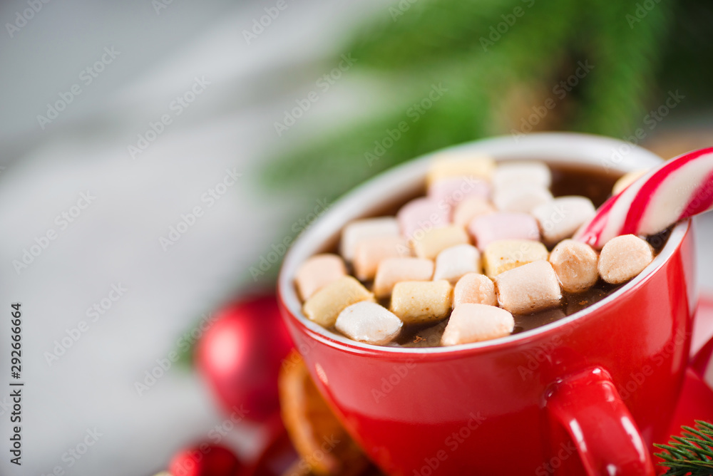 Red cup of hot chocolate with candy cone and marshmallows Red cup of hot chocolate with candy cone and marshmallows