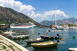 Kotor, Montenegro. A view to the Boka Kotor bay, small boats and giant sea liner.