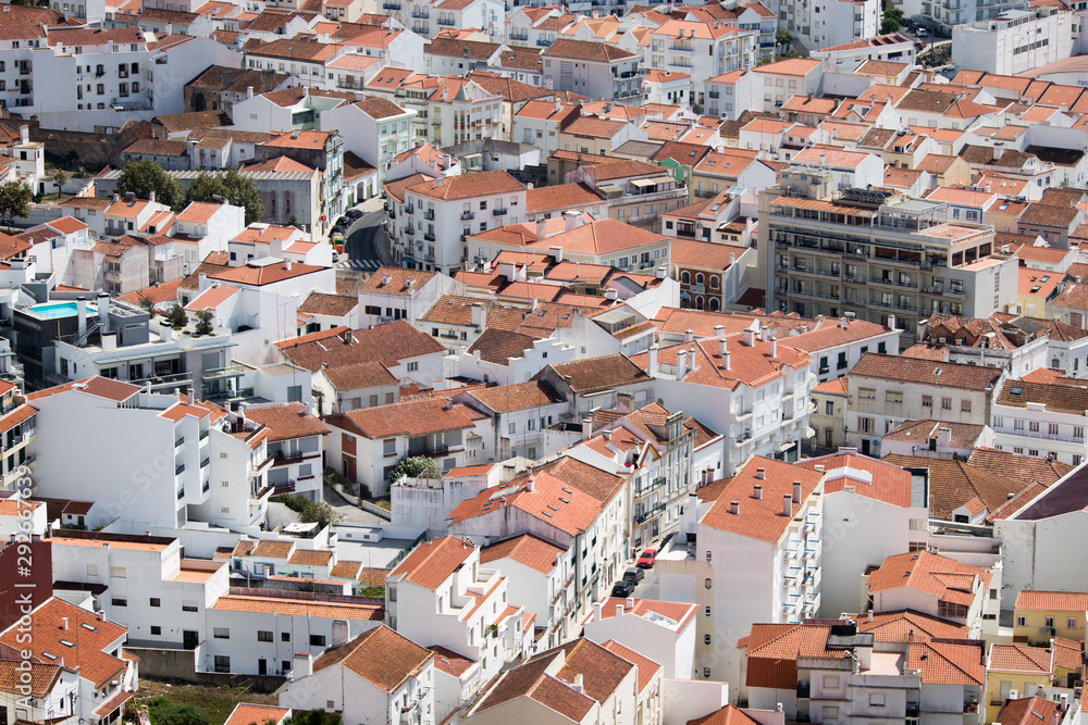 Red and Orange roofs of Nazare fishing village captured from Upper Town in Nazare, Portugal
