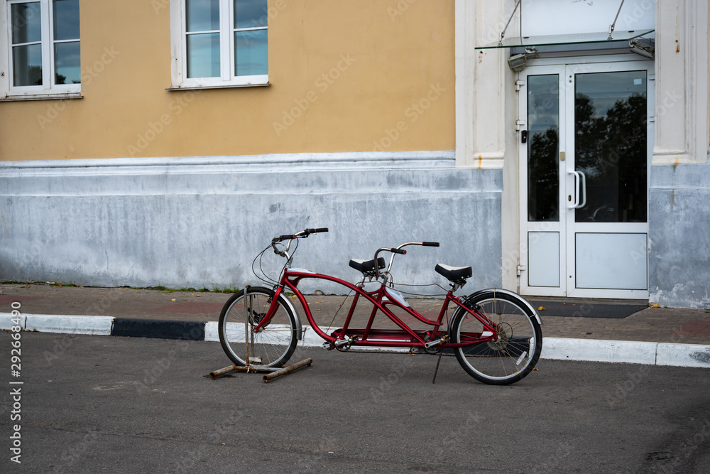 Red Tandem bike. Picture of tandem bicycle on the street city Red Tandem bike. Picture of tandem bicycle on the street city