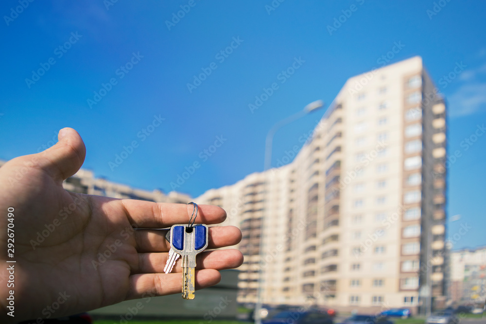 keys in hands on the background of a building under construction keys in hands on the background of a building under construction