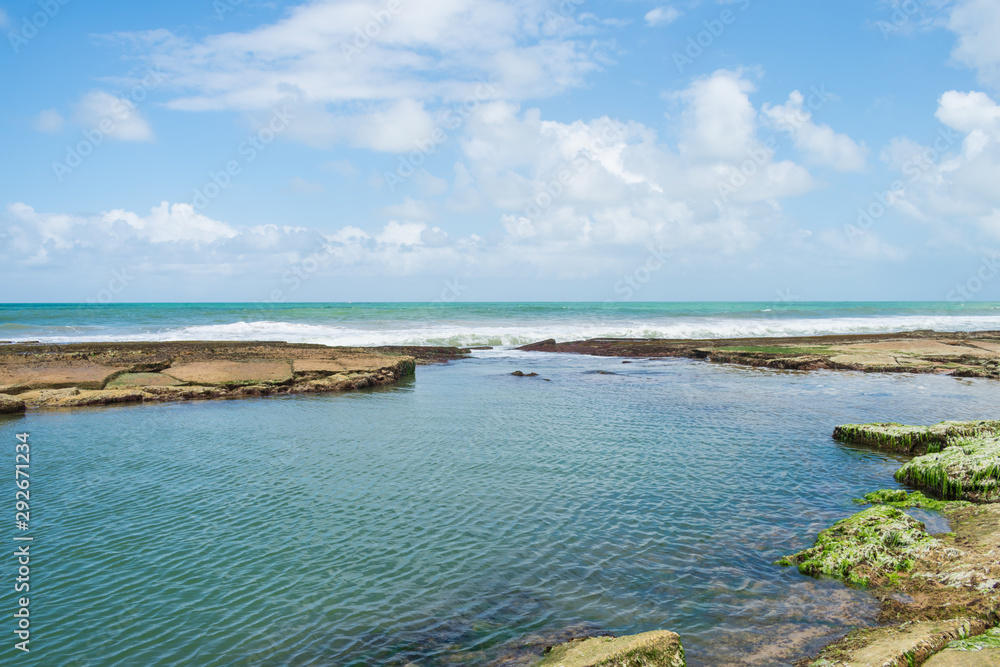Natural swimming pool at the beach near the Hippie village in Arembepe (Bahia, Brazil)