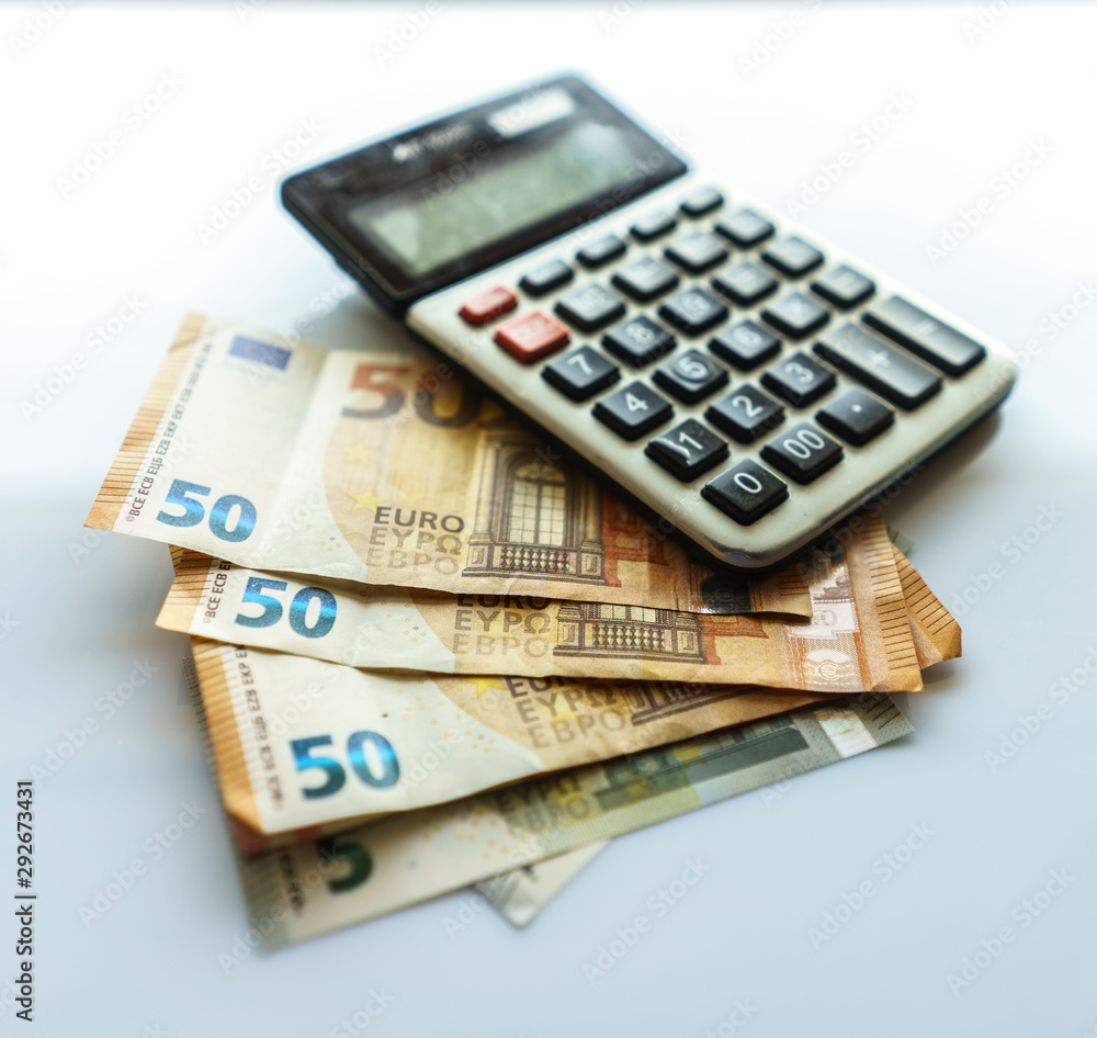 Banknotes and Calculator, Euro Banknotes on White Background Banknotes and Calculator, Euro Banknotes on White Background