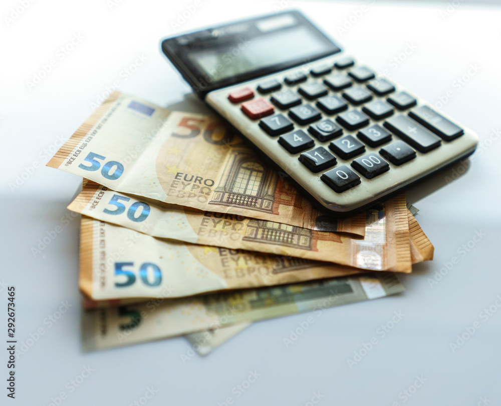 Banknotes and Calculator, Euro Banknotes on White Background Banknotes and Calculator, Euro Banknotes on White Background