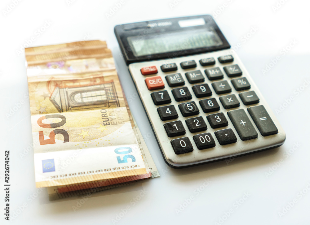 Banknotes and Calculator, Euro Banknotes on White Background Banknotes and Calculator, Euro Banknotes on White Background