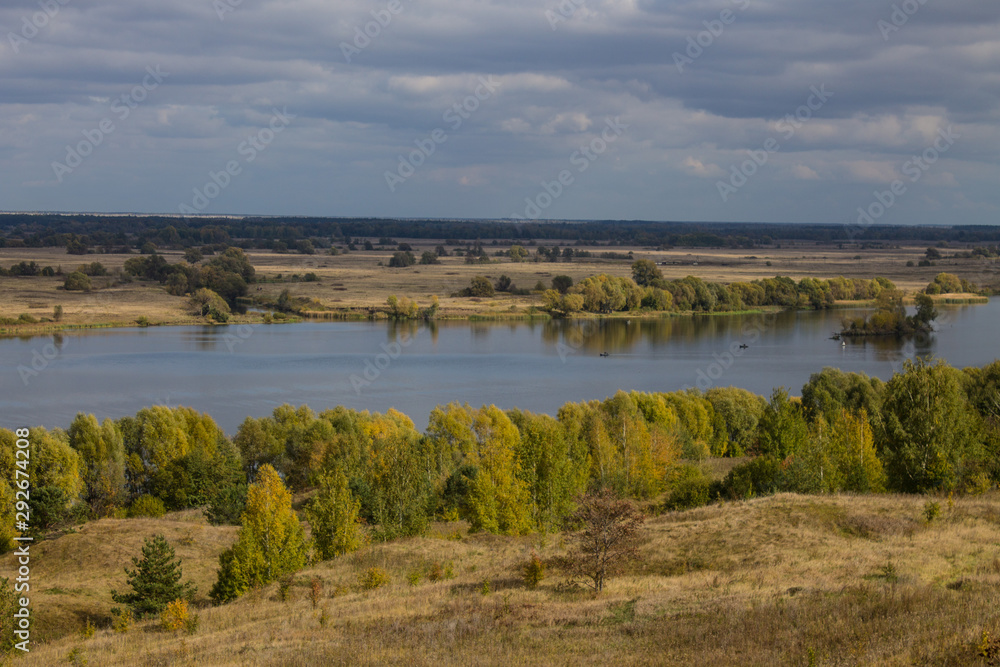 Autumn panoramic landscape with river and hills cloudy day in Konstantinovo village Russia