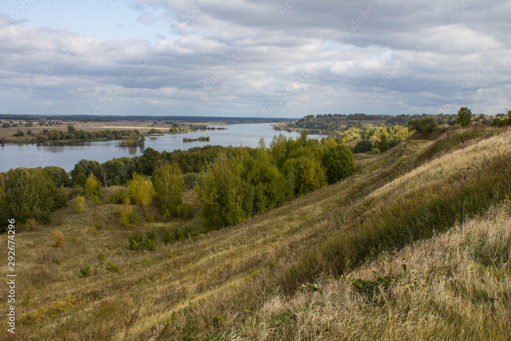 Obraz premium Autumn panoramic landscape with river and hills cloudy day in Konstantinovo village Russia