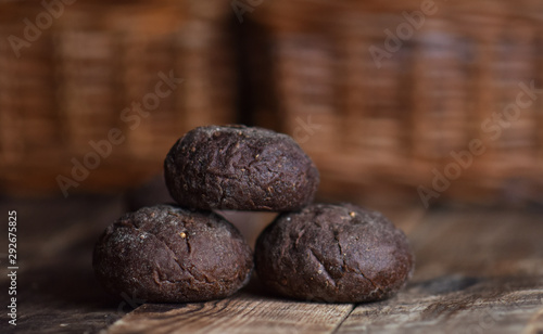 brown rye buns with cumin on a wooden table