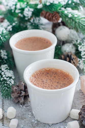 two glasses with hot chocolate in Christmas decorations, selective focus