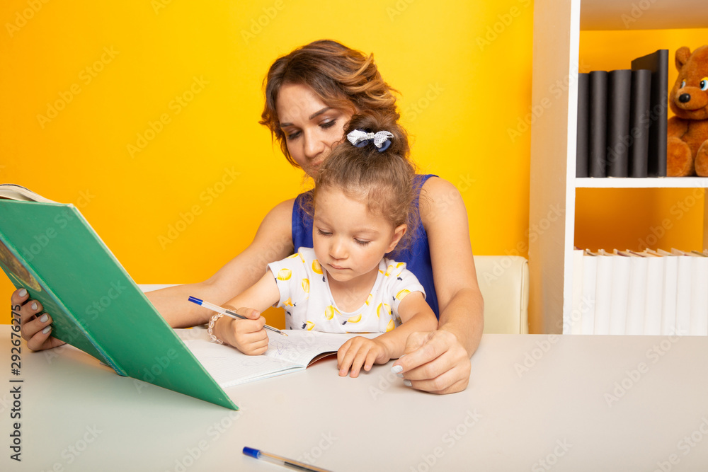 Portrait of mother and kid together in a preschool studying Portrait of mother and kid together in a preschool studying