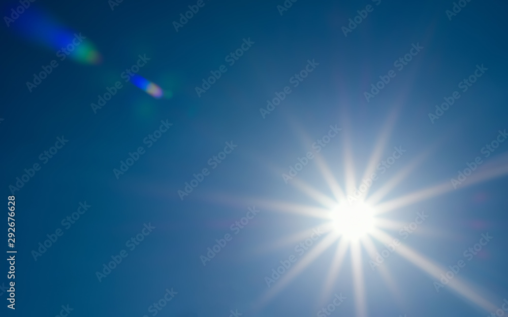 solar glow with lens flare in the clear blue sky solar glow with lens flare in the clear blue sky