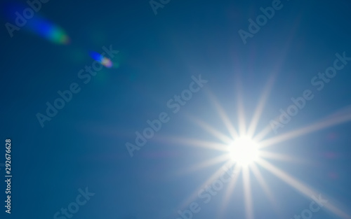 solar glow with lens flare in the clear blue sky