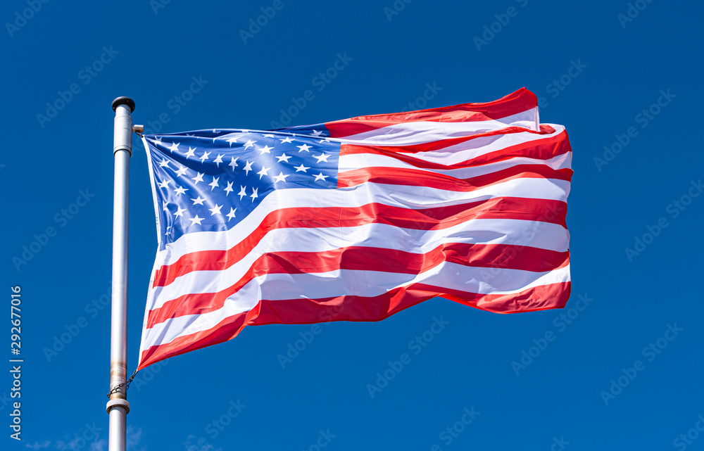 Fototapeta premium USA Flag and blue Sky as Background, American Flag waving on flagpole, New York
