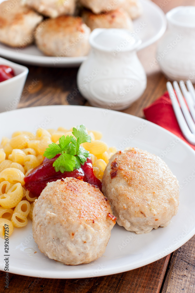 Homemade turkey cutlets with cheese filling on a white plate, selective focus Homemade turkey cutlets with cheese filling on a white plate, selective focus